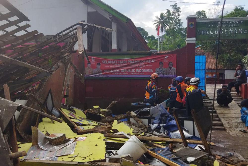 In photo released by Indonesian National Search and Rescue Agency (BASARNAS), rescuers inspect a school damaged by earthquake in Cianjur, West Java, Indonesia