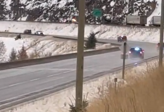 Police drive along the Coquihalla amid a situation