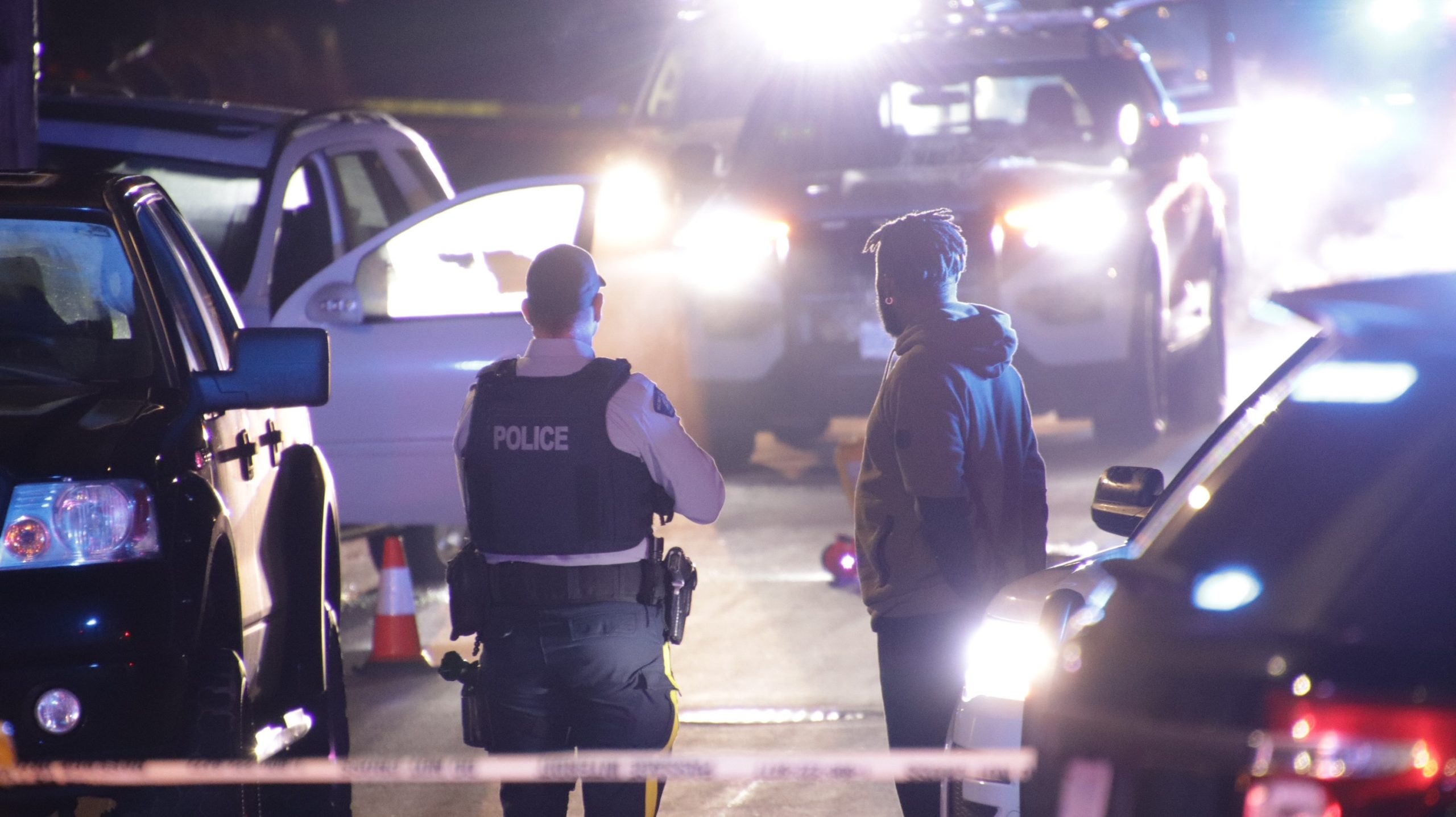 Police vehicles on a dark street