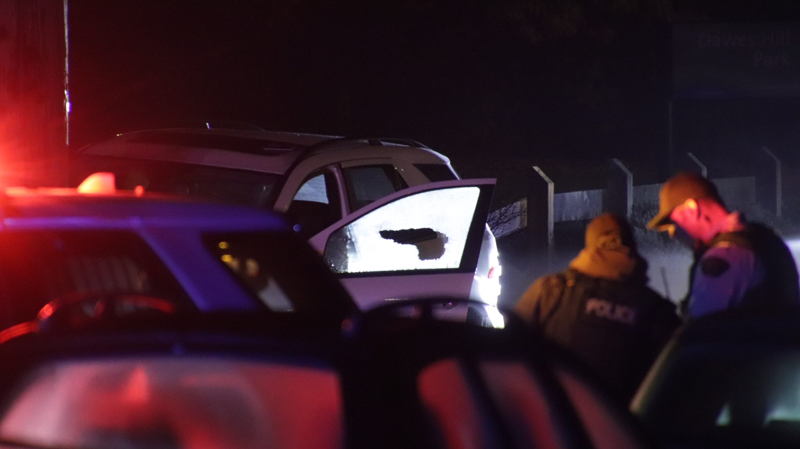 Police vehicles on a dark street