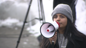 woman holds up microphone 