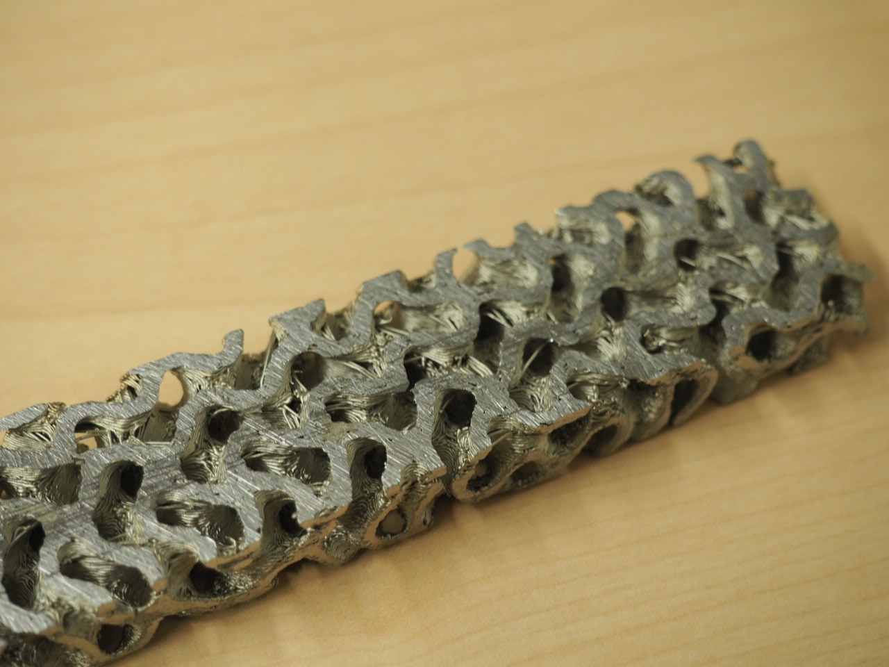 A 3D printed metallic strip, similar to the kind that the group is considering for making ship components from