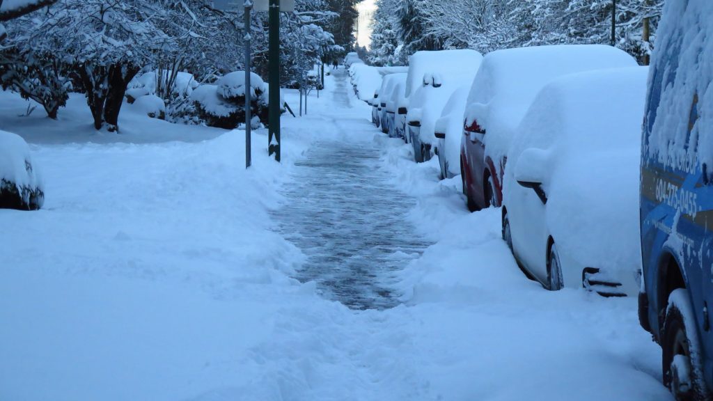 Snow covered Vancouver sidewalk.