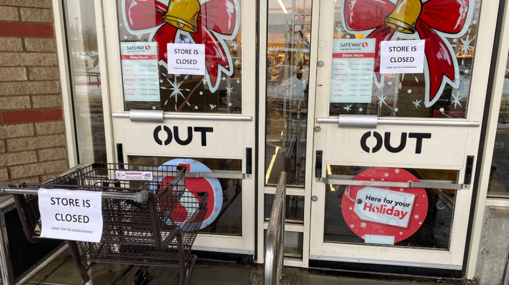 The doors of a Safeway grocery store in Surrey that is closed because its ceiling flooded.