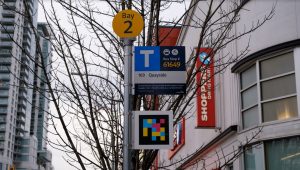 a bus stop on a pole has a specialzed code underneath the sign