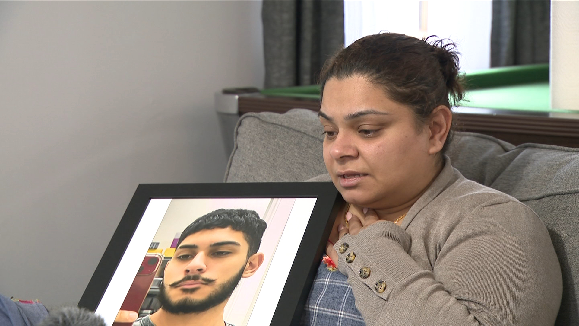 The mother of Taren Lal, a teen killed in a crash in Langley, holds a photo of her son as she speaks to OMNI News