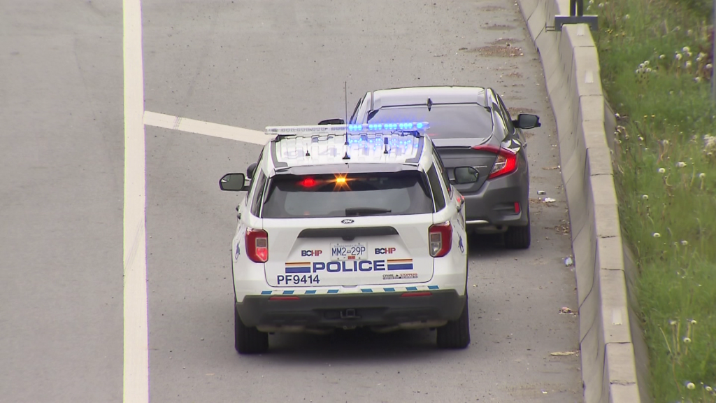 RCMP pull over a vehicle on a highway