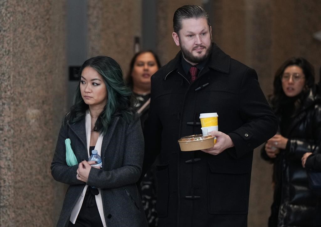 Jennifer Chan, front left, the sister of late Vancouver Police Const. Nicole Chan, who died by suicide in 2019, leaves a coroner's inquest, in Burnaby