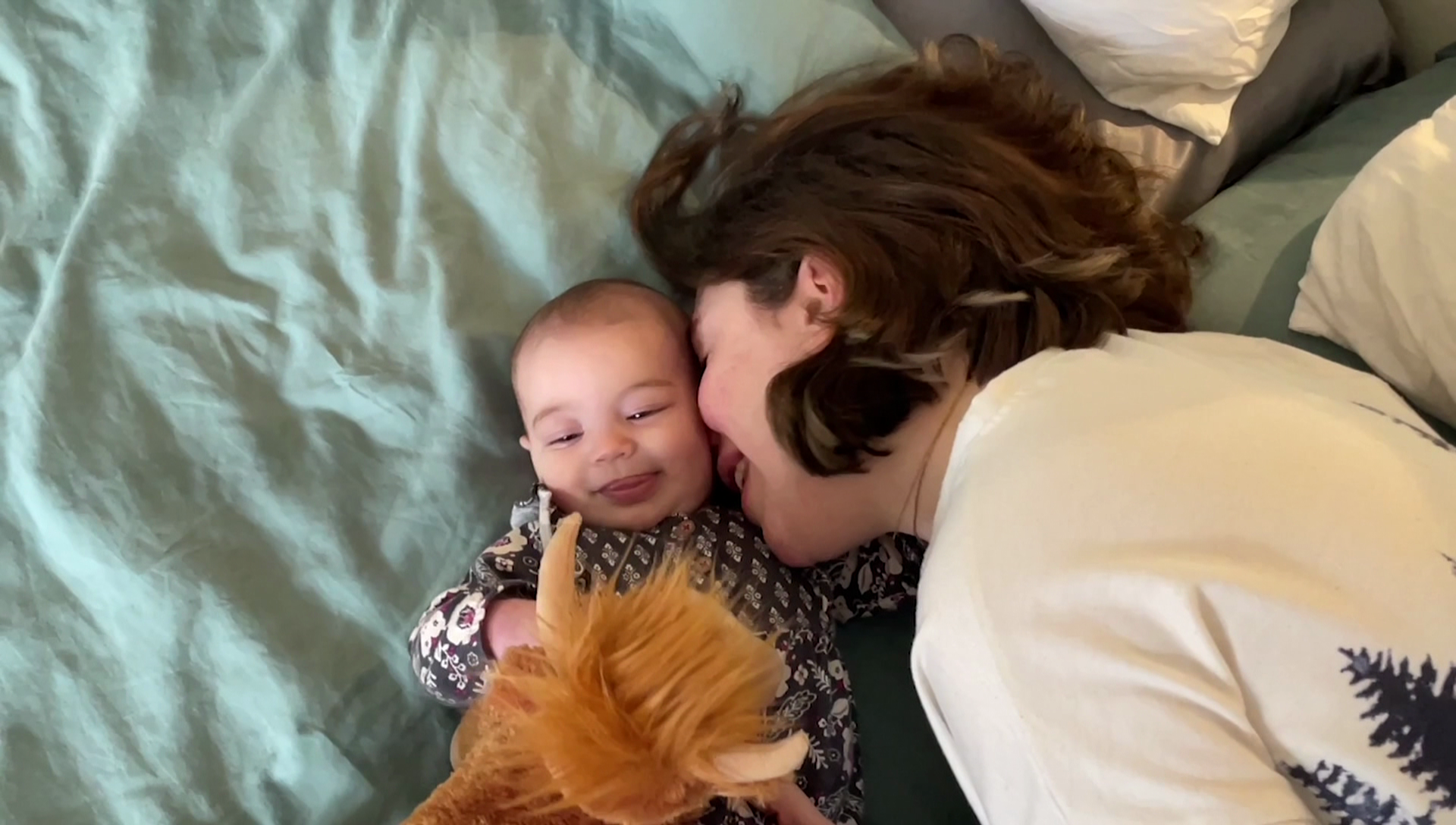 Vancouver woman Victoria Walsh is pictured laying with her baby on a bed