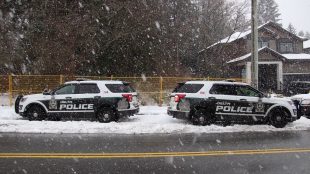 two delta police cruisers parked in the snow