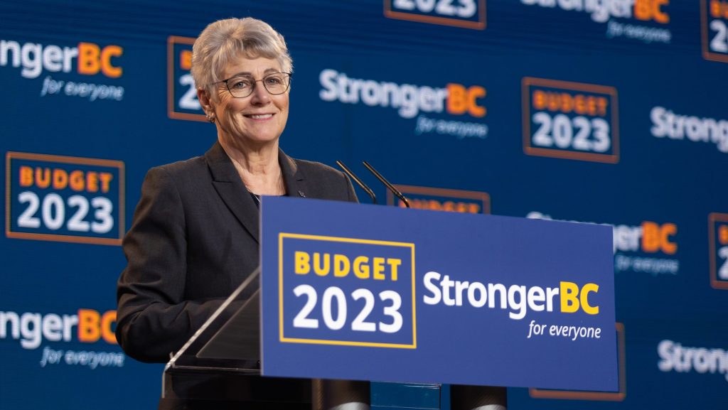 Katrine Conroy speaking at a podium