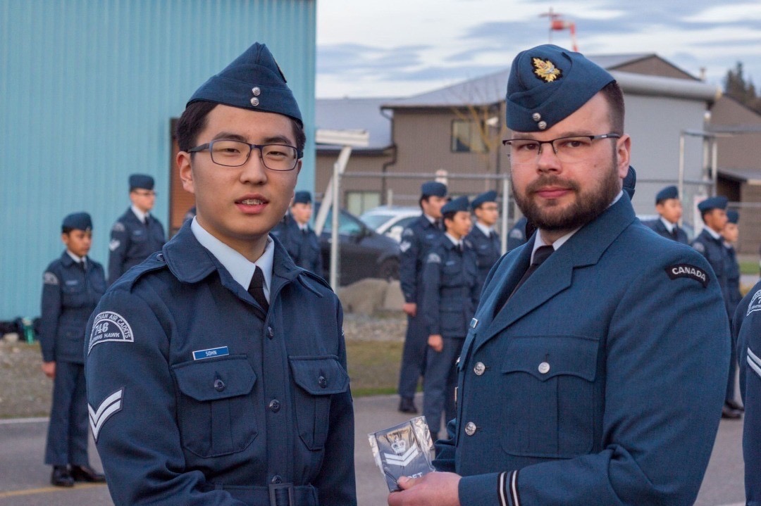 Kyle Sohn receiving a cadets medal from another uniformed man
