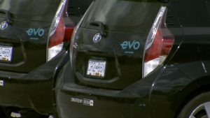 a line of parked evo car share vehicles