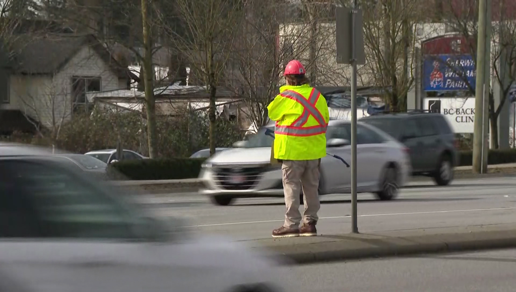 A police officer disguised standing on a median in Surrey