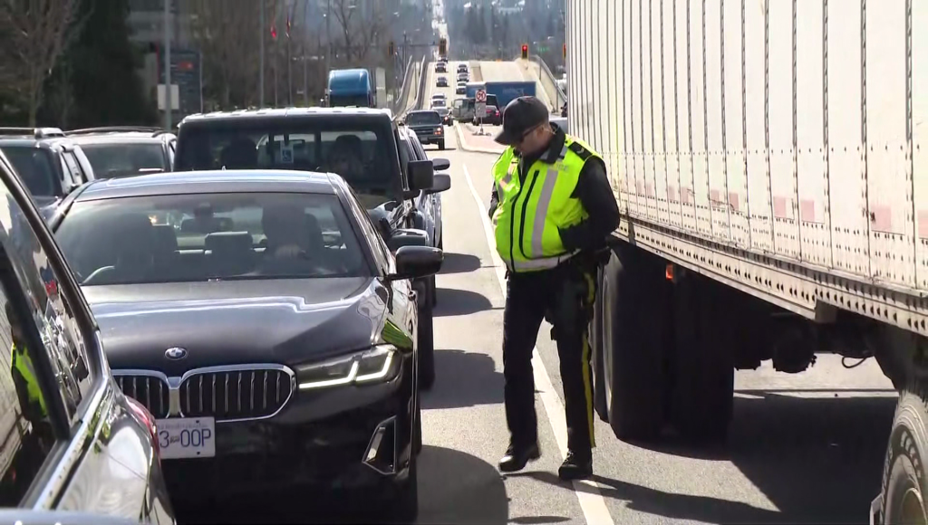 A police office stands in traffic