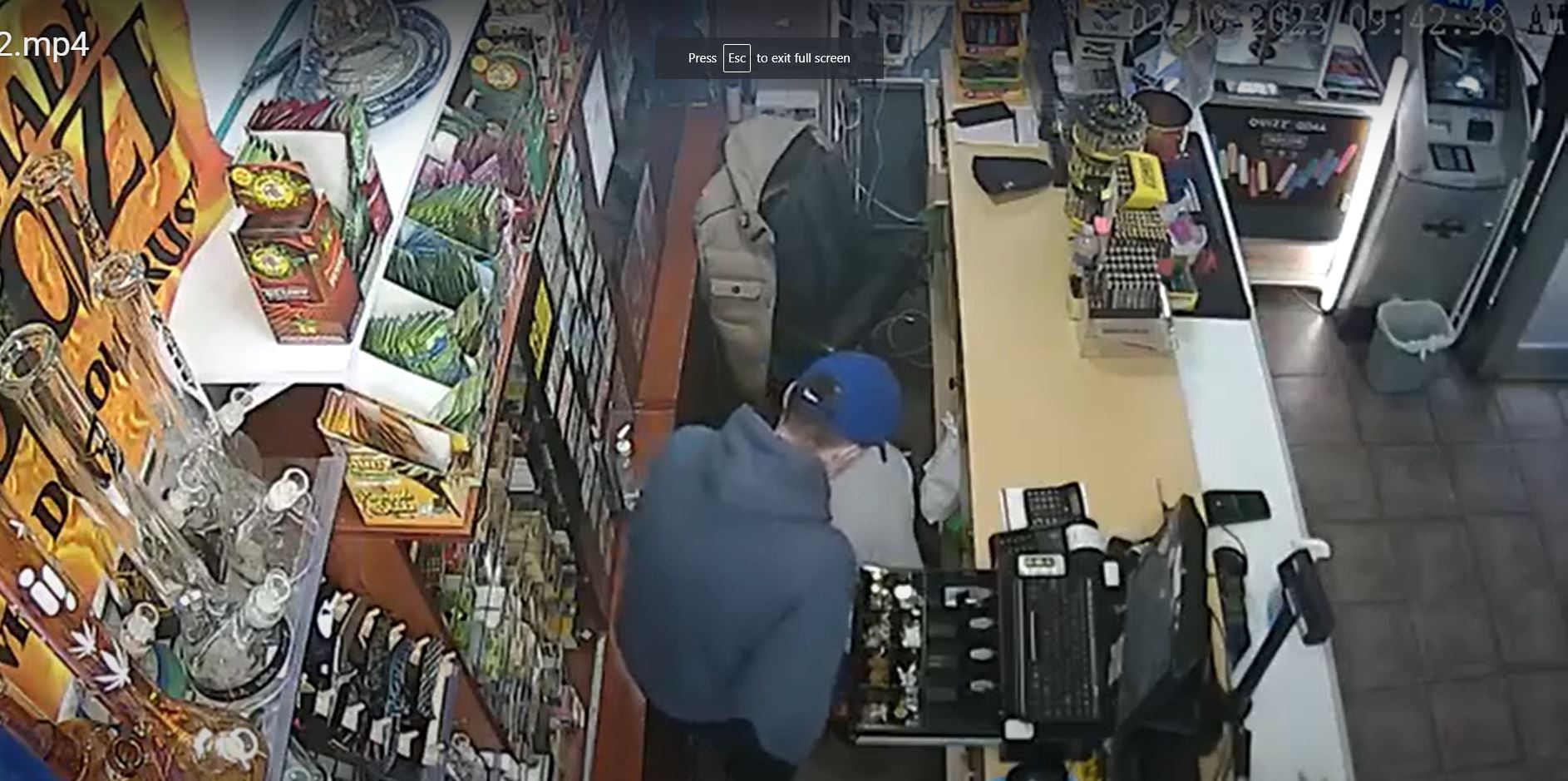 A surveillance video shows a robber clearing the till after being threatening the manager at Smoke and Good store with a knife 