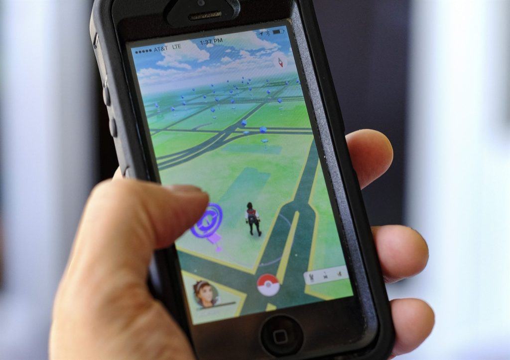 FILE - In this Friday, July 8, 2016, file photo, "Pokemon Go" is displayed on a cell phone in Los Angeles. Pokemon Go‚Äôs origins are as peculiar as any of the creatures inhabiting the game. (AP Photo/Richard Vogel, File)