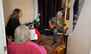 a trio of artists playing music