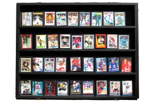 A large hockey card collection of Black players is displayed in long rows. 