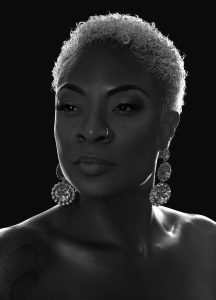 a head shot of singer jully black who was recently honoured for singing O canada as our home on native land