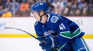 vancouver canucks elias peterson on the ice in a blue and green jersey