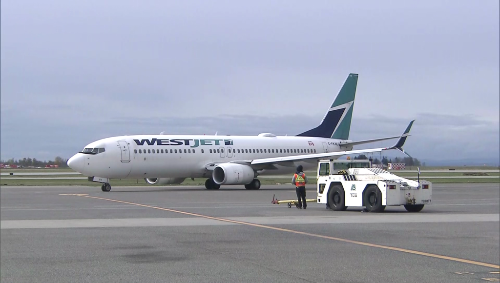 A WestJet plane on the tarmac at Vancouver International Airport