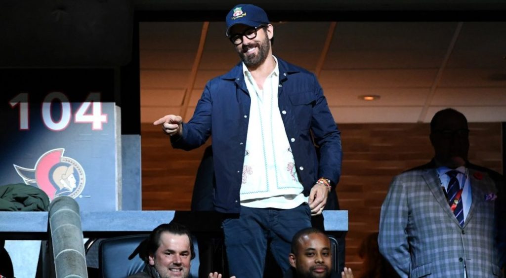 Actor Ryan Reynolds gestures towards a fan as he is recognized during a break in the play as the Ottawa Senators take on the Vancouver Canucks in Ottawa, on Tuesday, Nov. 8, 2022.