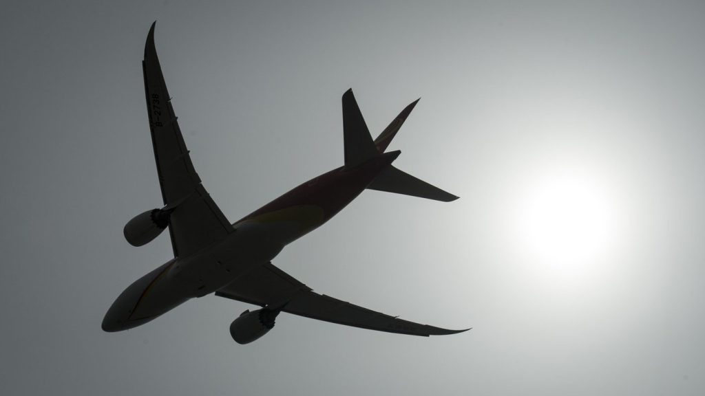 A plane is silhouetted as it takes off.