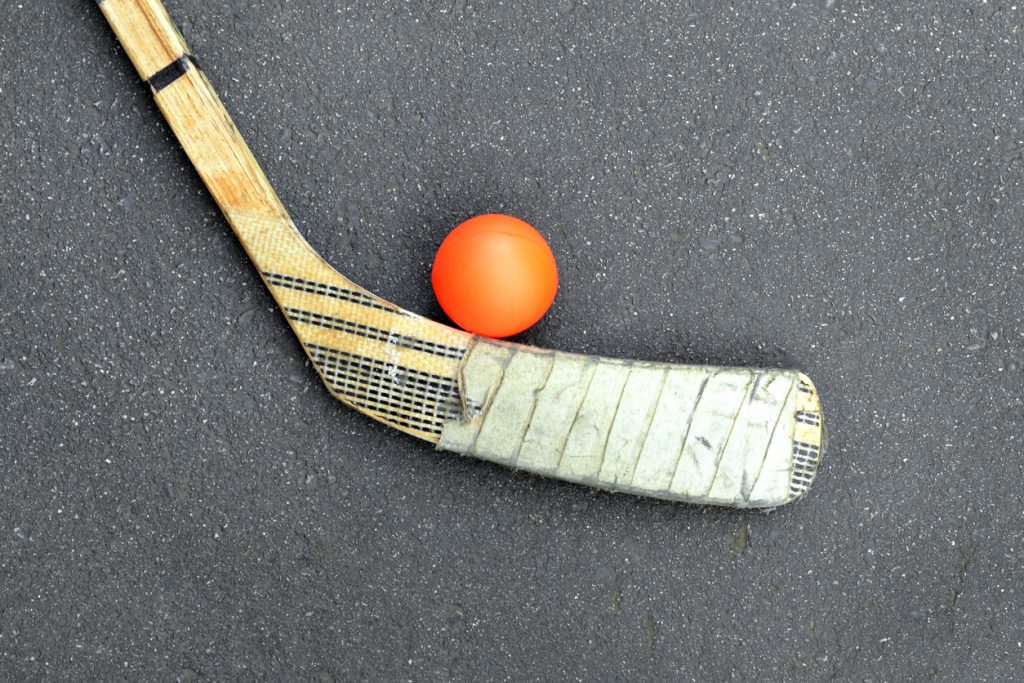 A ball hockey ball and stick