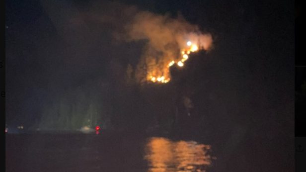 a fire is seen on a mountain like hill