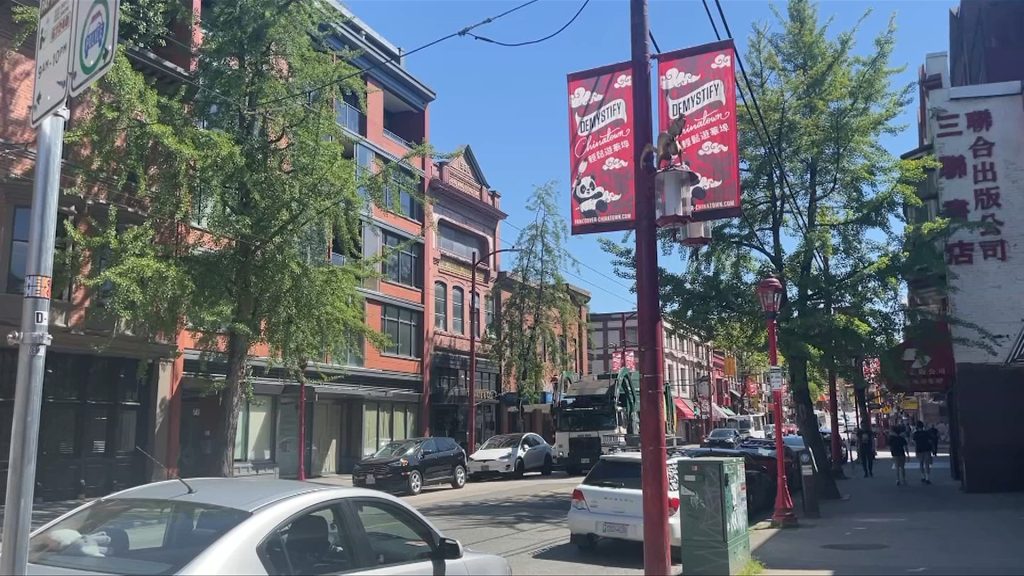 vancouvers historic chinatown buildings and street. crews were in the neighbourhood to help clean up the area of trash