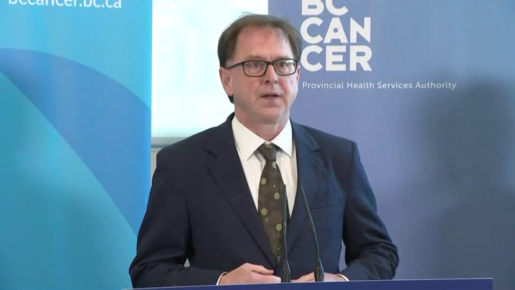 B.C. Health Minister Adrian Dix stands at a podium to make an announcement