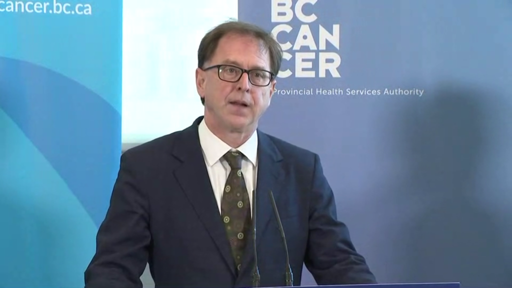 B.C. Health Minister Adrian Dix stands at a podium to make an announcement