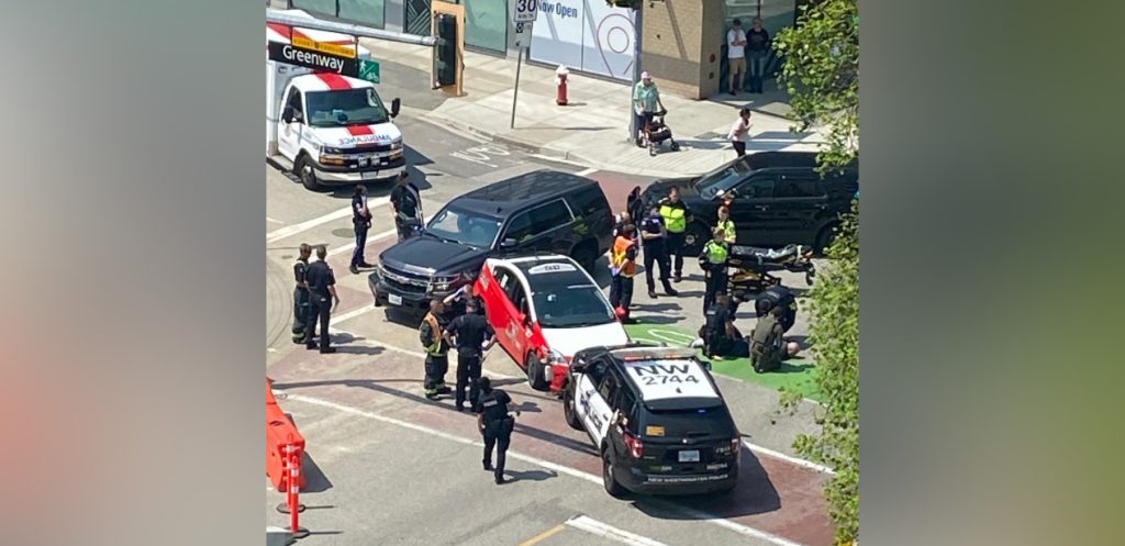 A taxi is surrounded by police vehicles in New Westminster after a police chase