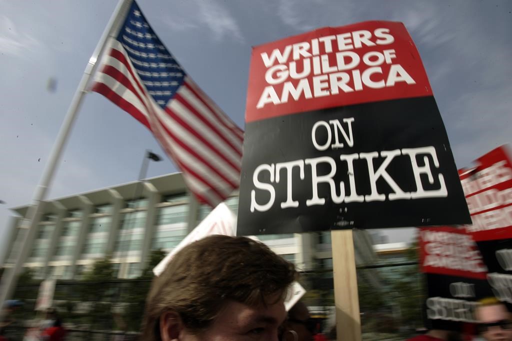 FILE - Writers Guild of America (WGA) writers and others strike against the Alliance of Motion Picture and Television Producers (AMPTP) in a rally at Fox Plaza in Los Angeles' Century City district on Nov. 9, 2007. Television and movie writers on Monday, May 1, 2023, declared that they will launch an industrywide strike for the first time since 2007, as Hollywood girded for a shutdown in a dispute over fair pay in the streaming era. (AP Photo/Reed Saxon, File)