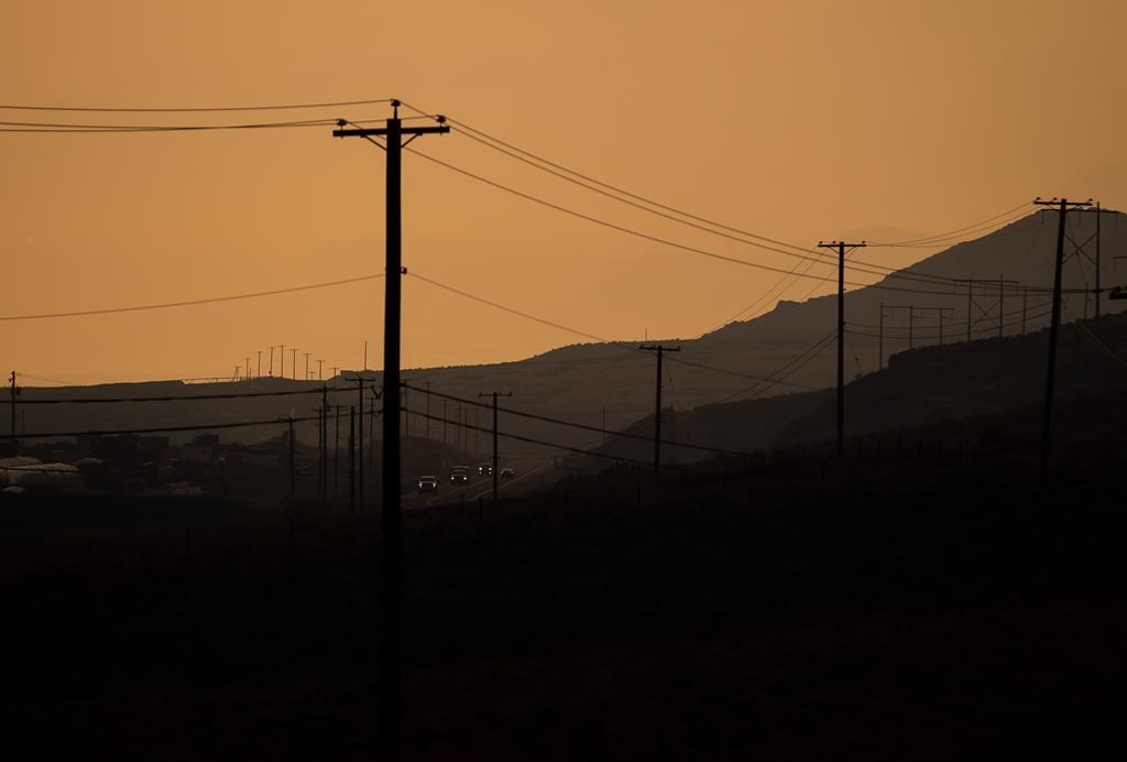 The landscape is dotted with power lines and poles as smoke from wildfires burning in the area fills the air while motorists travel on the Trans-Canada Highway near Walhachin, B.C., on Thursday, July 15, 2021. BC Hydro is expecting potentially record-breaking demand on the power system as the province enters what is forecast to be a blistering heat wave. THE CANADIAN PRESS/Darryl Dyck