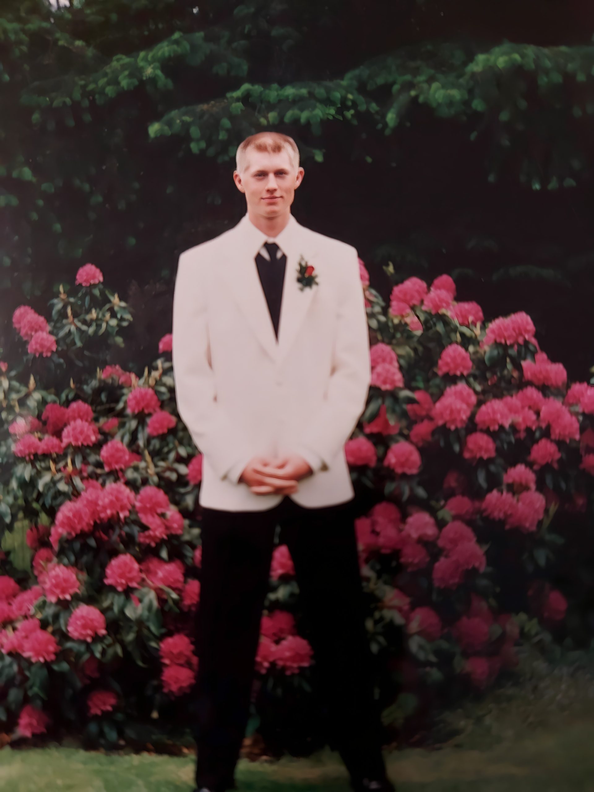 Tyler was one of the victims found at the site of the Whiskey Creek incident in Nov. 2020. In this photo, he's a teen dressed in a white suit jacket and is wearing dark pants and a tie for a formal occasion