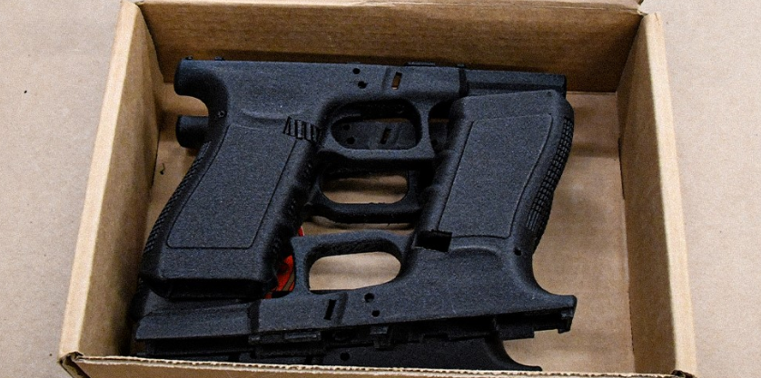 3-D printed guns are seen in a box.