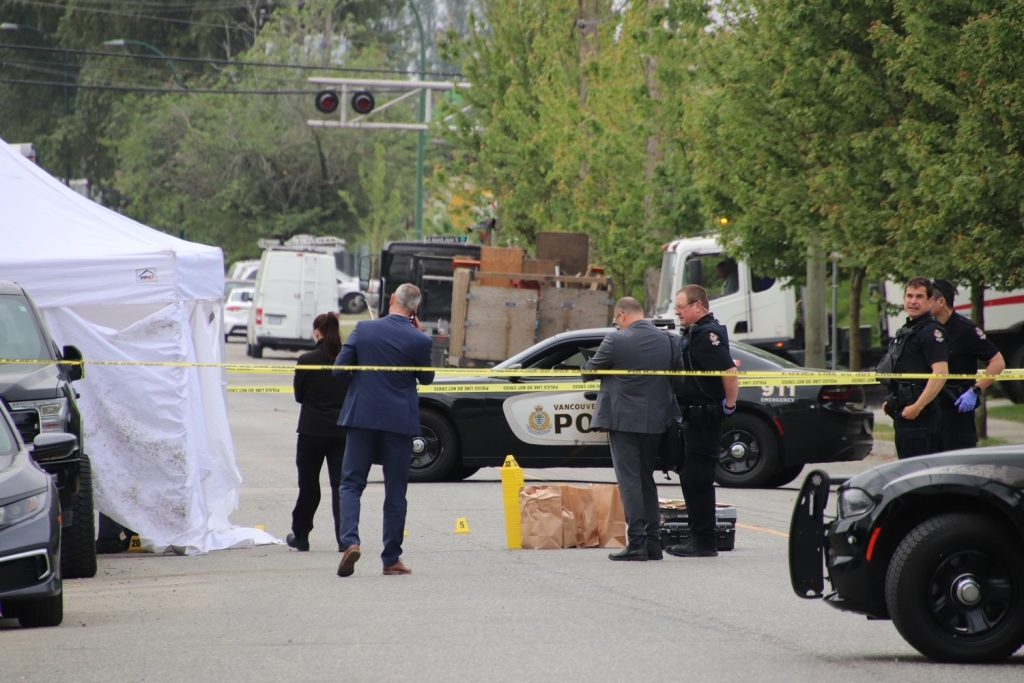 police officers in south vancouver with police tape seen around