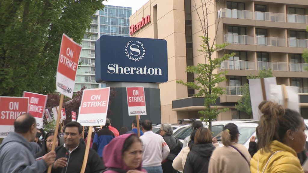 Workers strike outside of a hotel near YVR