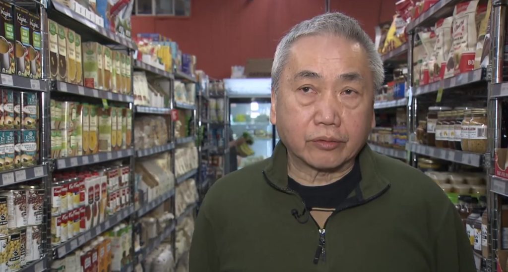 a man stands inside of his grocery store that was broken into on wednesady. he says a man stole food and not money