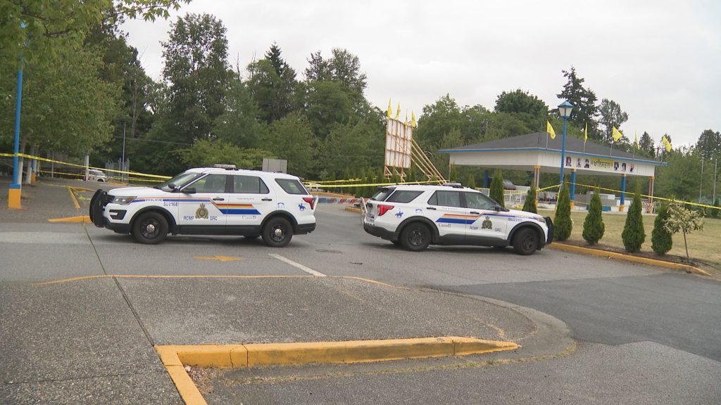 Yellow police tape blocks a parking lot where a shooting took place