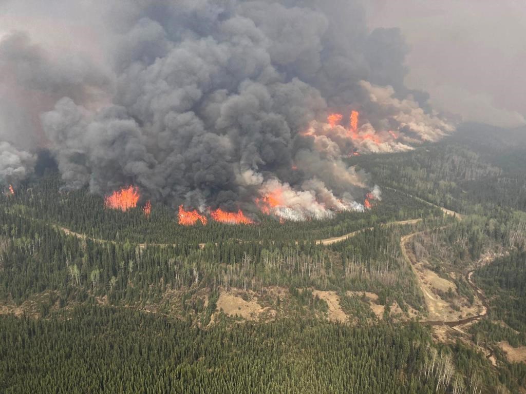 smoke flames are seen in this photo of the donnie creek wildfire burning in bc