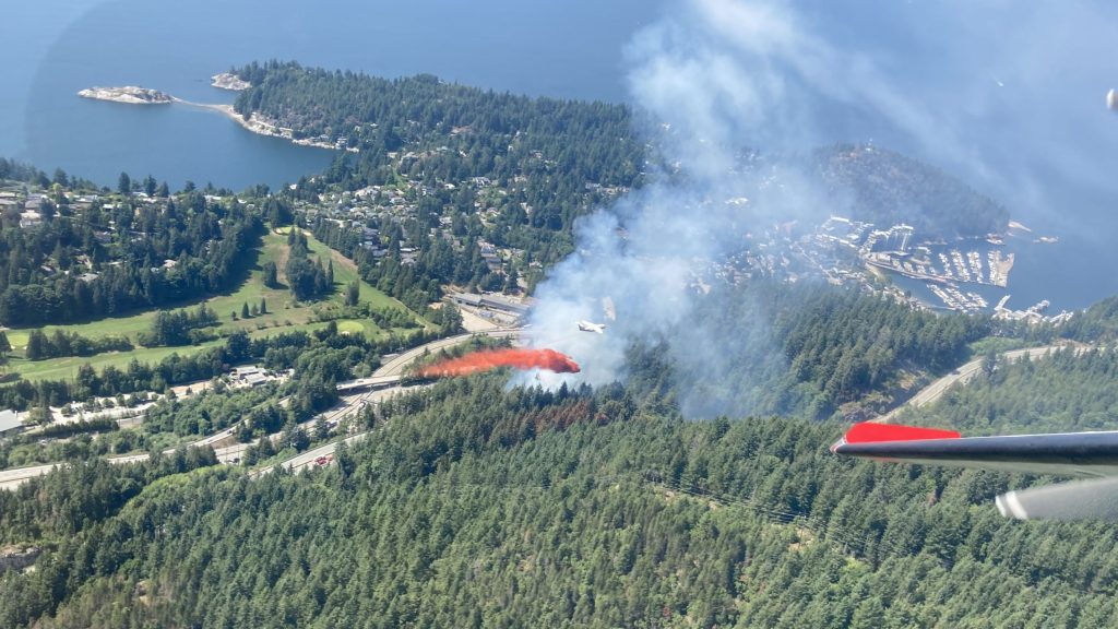 View of a tanker dropping fire retardant on a fire from above