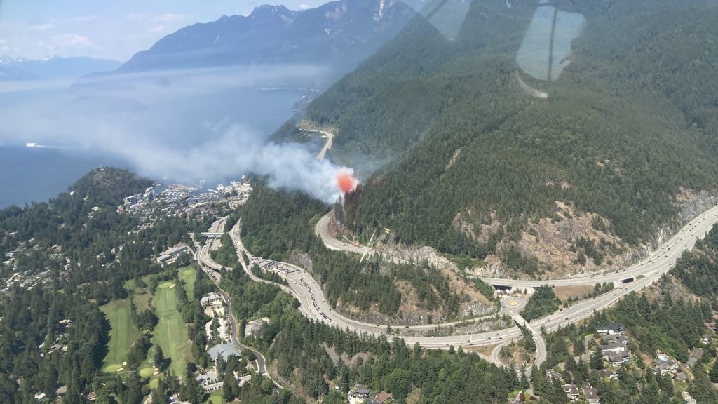 View of a tanker dropping fire retardant on a fire from above