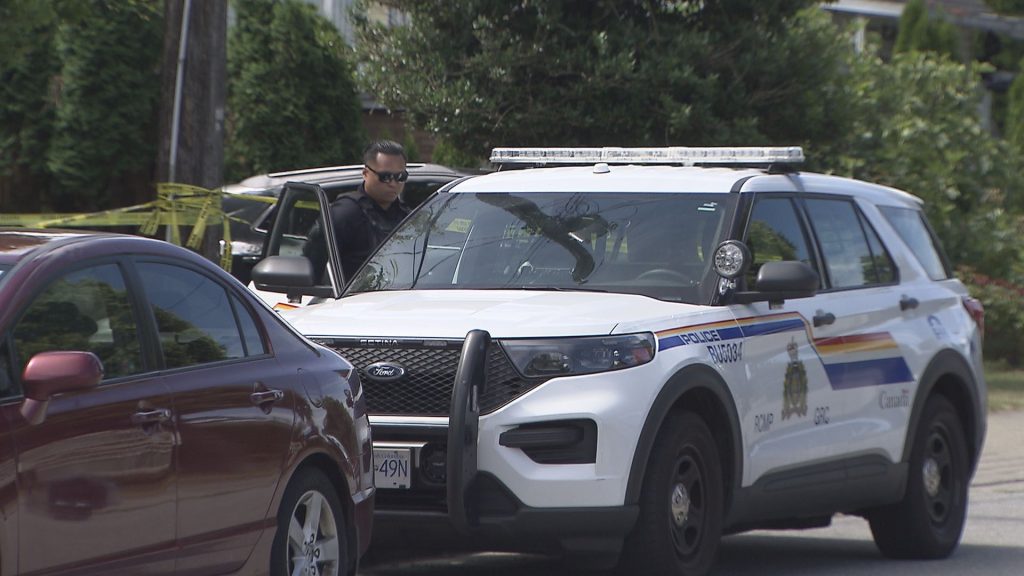 A home sits behind police tape