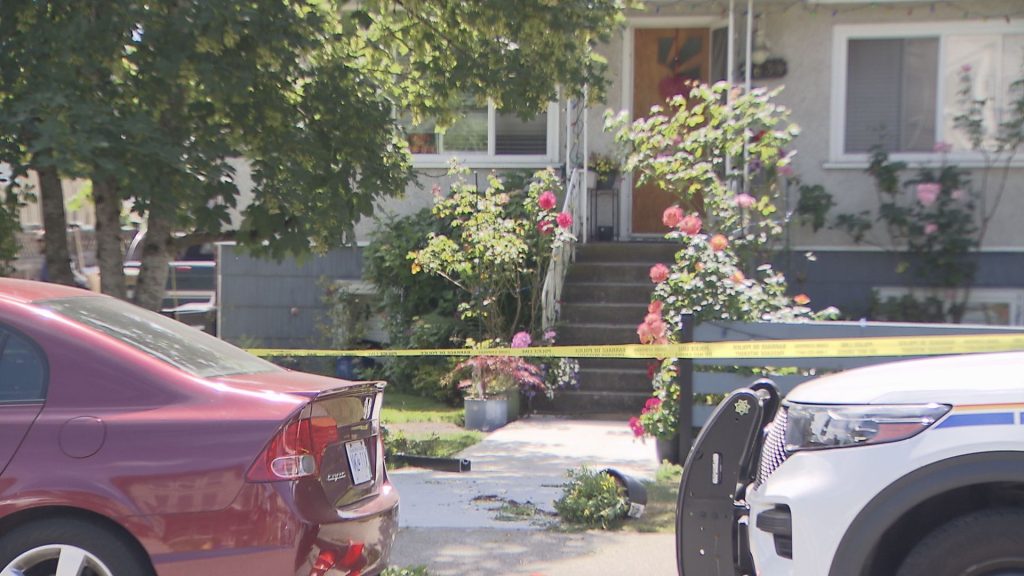 A home sits behind police tape