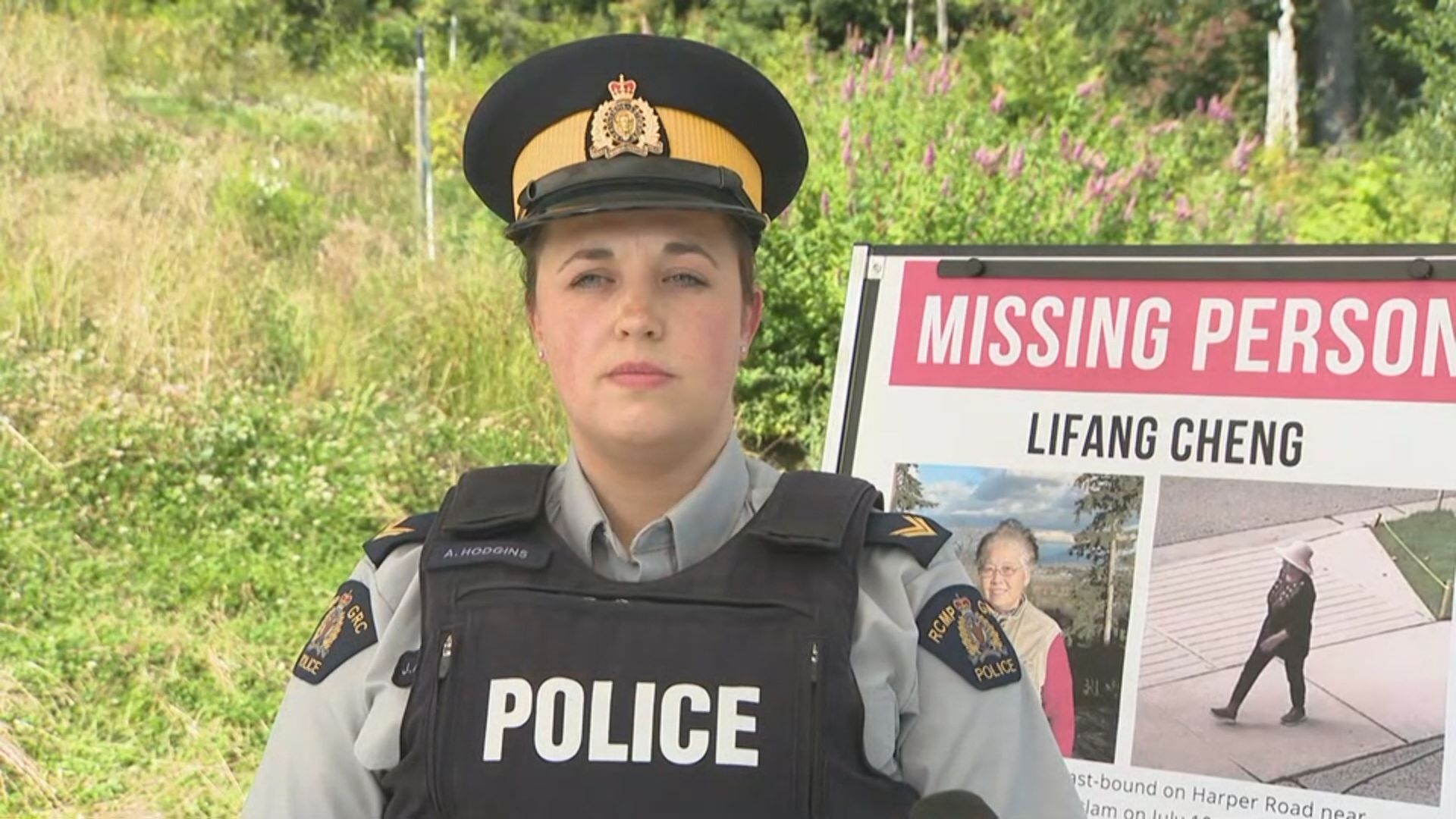 Cpl. Alexa Hodgins speaks next to a missing person placard