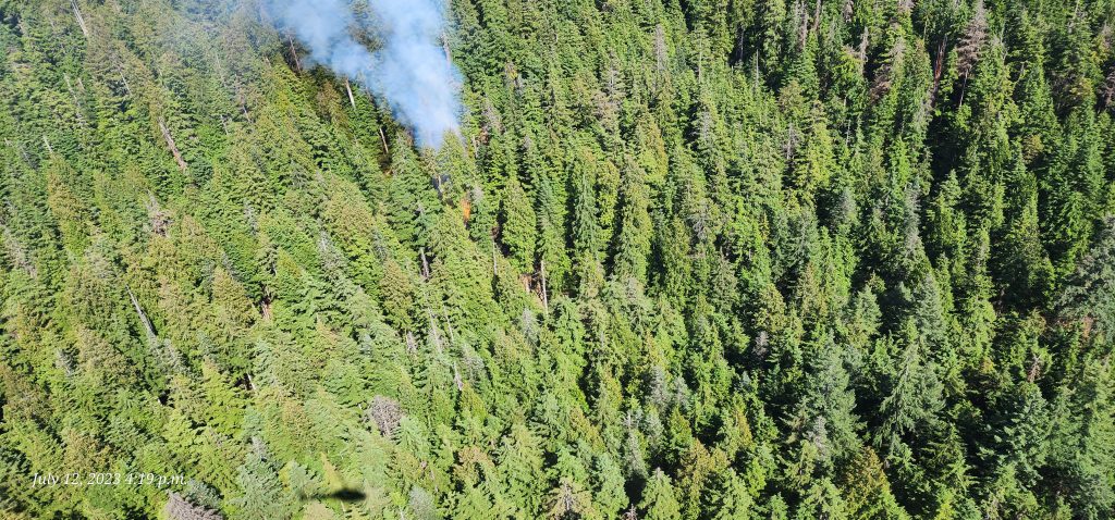 Smoke from the wildfire on Mount Seymour in the District of North Vancouver rises from among the heavy forested area on Wednesday, July 13, 2023.