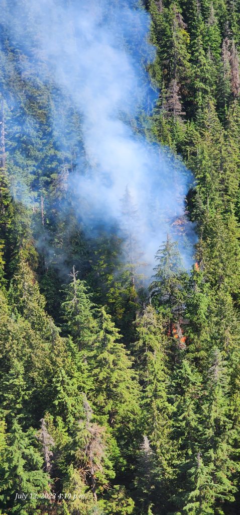 Smoke from the wildfire on Mount Seymour in the District of North Vancouver rises from among the heavy forested area on Wednesday, July 12, 2023.